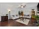 Spacious living room with hardwood floors, neutral furniture, ceiling fan, and decorative shelves at 5384 Gatsby Cir, Rock Hill, SC 29732
