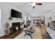 Open-concept living room featuring a fireplace, hardwood floors, and seamless flow into the kitchen and dining area at 5384 Gatsby Cir, Rock Hill, SC 29732