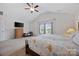 Spacious main bedroom featuring a large window, vaulted ceiling, tv and ensuite bathroom at 5384 Gatsby Cir, Rock Hill, SC 29732