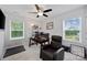 Office with two windows, computer setup, fan, and a comfortable looking brown leather chair at 5384 Gatsby Cir, Rock Hill, SC 29732