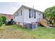 View of the home's backyard featuring a patio set, brick foundation and A/C unit at 55 Ranlo Ave, Gastonia, NC 28054