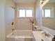 Bright bathroom with a tub and shower combination, window, and stylish sink and faucet at 55 Ranlo Ave, Gastonia, NC 28054