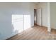 Bedroom with white walls, light wood floors, a window, and a closet door at 55 Ranlo Ave, Gastonia, NC 28054