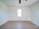 A bright bedroom with hardwood floors and a window provides ample natural light at 55 Ranlo Ave, Gastonia, NC 28054