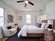 Bright bedroom with a modern bed, hardwood floors, white walls, and a sitting area at 55 Ranlo Ave, Gastonia, NC 28054