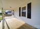 Inviting covered front porch featuring new wood floors and black shutters at 55 Ranlo Ave, Gastonia, NC 28054