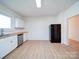 Bright kitchen featuring white cabinets, butcher block countertops, and stainless appliances at 55 Ranlo Ave, Gastonia, NC 28054