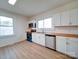 Bright kitchen featuring white cabinets, butcher block countertops, and stainless appliances at 55 Ranlo Ave, Gastonia, NC 28054