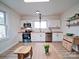 Bright kitchen featuring white cabinets, butcher block countertops, and stainless appliances at 55 Ranlo Ave, Gastonia, NC 28054