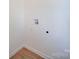 Close up on the laundry room hookups with white walls and light wood floor at 55 Ranlo Ave, Gastonia, NC 28054