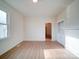 Bright living room with hardwood floors, large window, and a doorway leading to the next room at 55 Ranlo Ave, Gastonia, NC 28054