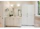 Bright bathroom featuring white cabinets, a large mirror, and neutral tile flooring at 5701 Challisford Ln, Charlotte, NC 28226