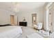 This bright bedroom has a seating area, an ensuite bathroom and is decorated in neutral colors at 5701 Challisford Ln, Charlotte, NC 28226
