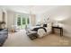 Spacious bedroom features a chandelier, access to yard through french doors and neutral decor at 5701 Challisford Ln, Charlotte, NC 28226