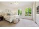 Bedroom filled with natural light, features two arched windows, and neutral decor at 5701 Challisford Ln, Charlotte, NC 28226