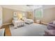 Bright bedroom with hardwood floors, twin beds, and a ceiling fan at 5701 Challisford Ln, Charlotte, NC 28226