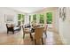 Bright breakfast nook with large windows, tile floors, and seating area at 5701 Challisford Ln, Charlotte, NC 28226