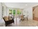 Bright breakfast nook with seating, tile floors, glass doors to the outside, and access to stairs at 5701 Challisford Ln, Charlotte, NC 28226