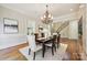 Elegant dining room features a chandelier, hardwood floors, and staircase in background at 5701 Challisford Ln, Charlotte, NC 28226