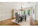 This dining room features hardwood floors, large windows with natural light, and built-in cabinetry at 5701 Challisford Ln, Charlotte, NC 28226