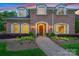 Charming brick home featuring a welcoming front entrance and manicured landscaping at 5701 Challisford Ln, Charlotte, NC 28226