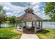 Scenic view of a gazebo by the lake with lush green surroundings and clear skies at 5701 Challisford Ln, Charlotte, NC 28226