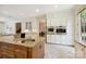 Kitchen with granite countertops, island with sink, stainless steel double ovens and tile floors at 5701 Challisford Ln, Charlotte, NC 28226