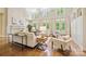 Spacious living room with fireplace, hardwood floors, and multiple seating areas at 5701 Challisford Ln, Charlotte, NC 28226