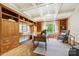Bright office space featuring custom cabinetry, hardwood floors, and coffered ceiling at 5701 Challisford Ln, Charlotte, NC 28226