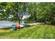 Lakeside view with colorful canoes, lush greenery, and serene waterfront scenery at 5701 Challisford Ln, Charlotte, NC 28226
