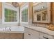 Bright bathroom with a soaking tub, marble countertop, and bay window overlooking the landscape at 6164 Dwayne Starnes Dr, Hickory, NC 28602