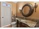 Elegant bathroom featuring a decorative mirror and granite vanity, complemented by a stylish door at 6164 Dwayne Starnes Dr, Hickory, NC 28602