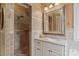 Bathroom featuring a tiled shower, vanity with marble countertop, and an ornate mirror at 6164 Dwayne Starnes Dr, Hickory, NC 28602