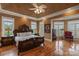 Spacious bedroom with hardwood floors, a decorative ceiling fan, and large windows for natural light at 6164 Dwayne Starnes Dr, Hickory, NC 28602