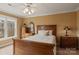 Comfortable bedroom featuring a wooden bed frame, dresser, and bedside table with a lamp at 6164 Dwayne Starnes Dr, Hickory, NC 28602