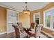 Charming dining room with a glass table, upholstered chairs, and a decorative light fixture at 6164 Dwayne Starnes Dr, Hickory, NC 28602