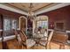 Formal dining room with a glass table, ornate chairs, hardwood floors, and detailed ceiling at 6164 Dwayne Starnes Dr, Hickory, NC 28602