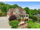 Stunning multi-story home with beautiful landscaping, a brick facade, covered porch and attached garage at 6164 Dwayne Starnes Dr, Hickory, NC 28602
