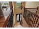 Grand foyer with a striking chandelier, dark wooden staircase, and decorative wrought iron at 6164 Dwayne Starnes Dr, Hickory, NC 28602