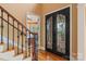 Elegant foyer with hardwood floors, a staircase, and a decorative wrought iron door at 6164 Dwayne Starnes Dr, Hickory, NC 28602