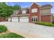 Spacious three-car garage with brick and shingle siding, complemented by a wide driveway and manicured lawn at 6164 Dwayne Starnes Dr, Hickory, NC 28602