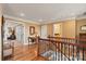 Hallway with hardwood floors, wood and wrought iron staircase, and views into other rooms at 6164 Dwayne Starnes Dr, Hickory, NC 28602