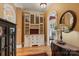 Hallway featuring a built-in hutch with leaded glass, arched doorway, and hardwood flooring at 6164 Dwayne Starnes Dr, Hickory, NC 28602