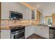 Well-equipped kitchen featuring white cabinets, granite countertops, and stainless steel appliances at 6164 Dwayne Starnes Dr, Hickory, NC 28602