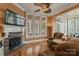 Inviting living room with a stone fireplace, hardwood floors, and large windows overlooking the backyard at 6164 Dwayne Starnes Dr, Hickory, NC 28602