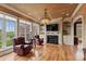 Elegant living room featuring a fireplace, built-in shelves, and large windows overlooking lush greenery at 6164 Dwayne Starnes Dr, Hickory, NC 28602