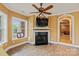 Cozy living room with a fireplace, a TV mounted above the mantle, and an arched doorway at 6164 Dwayne Starnes Dr, Hickory, NC 28602