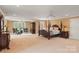 Large main bedroom featuring a four poster bed, sitting area, and neutral colored carpet at 6164 Dwayne Starnes Dr, Hickory, NC 28602