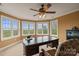 Office with a dark wood desk, wall of windows, and a decorative ceiling fan at 6164 Dwayne Starnes Dr, Hickory, NC 28602