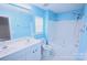 Bright bathroom with double sinks, tile flooring, and a tub with shower at 6614 Wicked Oak Ln, Charlotte, NC 28216